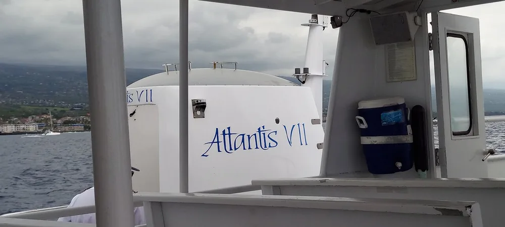 Guest photo from the deck of the white Atlantis shuttle boat, with its name painted on the cabin